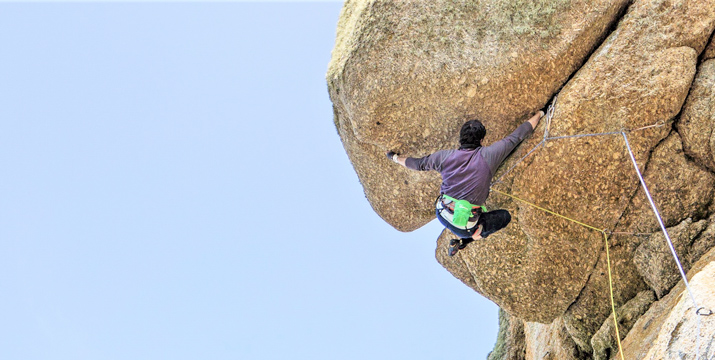 Climber attempts the roof crack on Superjam (E5) at Sennen, showcasing one of Cornwall’s hardest sea cliff climbs.