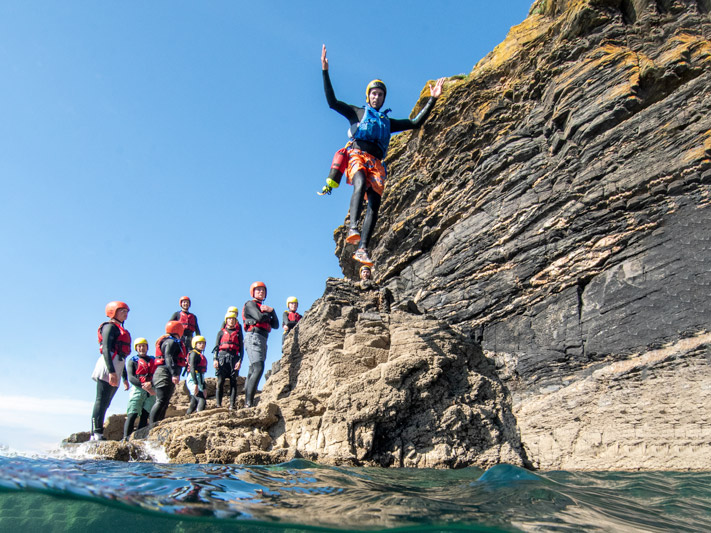 Coasteering guide leads a group at Praa Sands on Cornwall’s south coast.