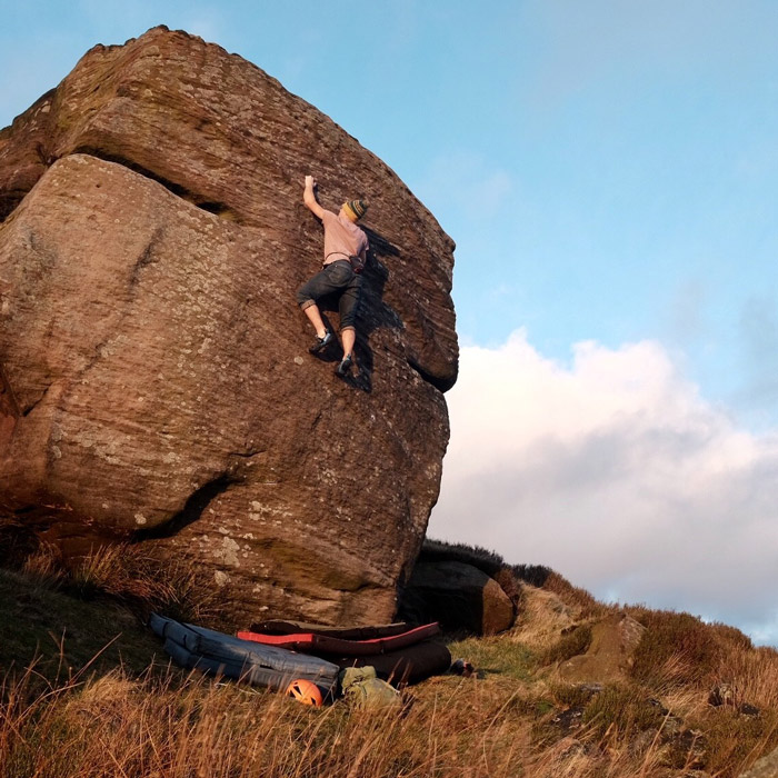 Tom, one of our rock climbing instructors, bouldering on gritstone in the Peak District