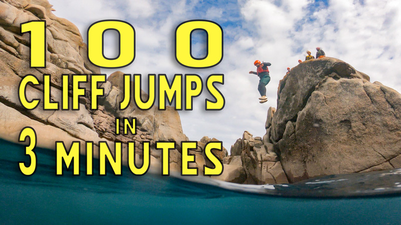 Person mid-jump from granite cliff during a coasteering session in Cornwall, with bold title text overlay