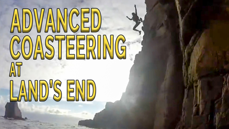 Silhouetted jumper leaps from high granite cliffs during an advanced coasteering session at Land’s End, Cornwall