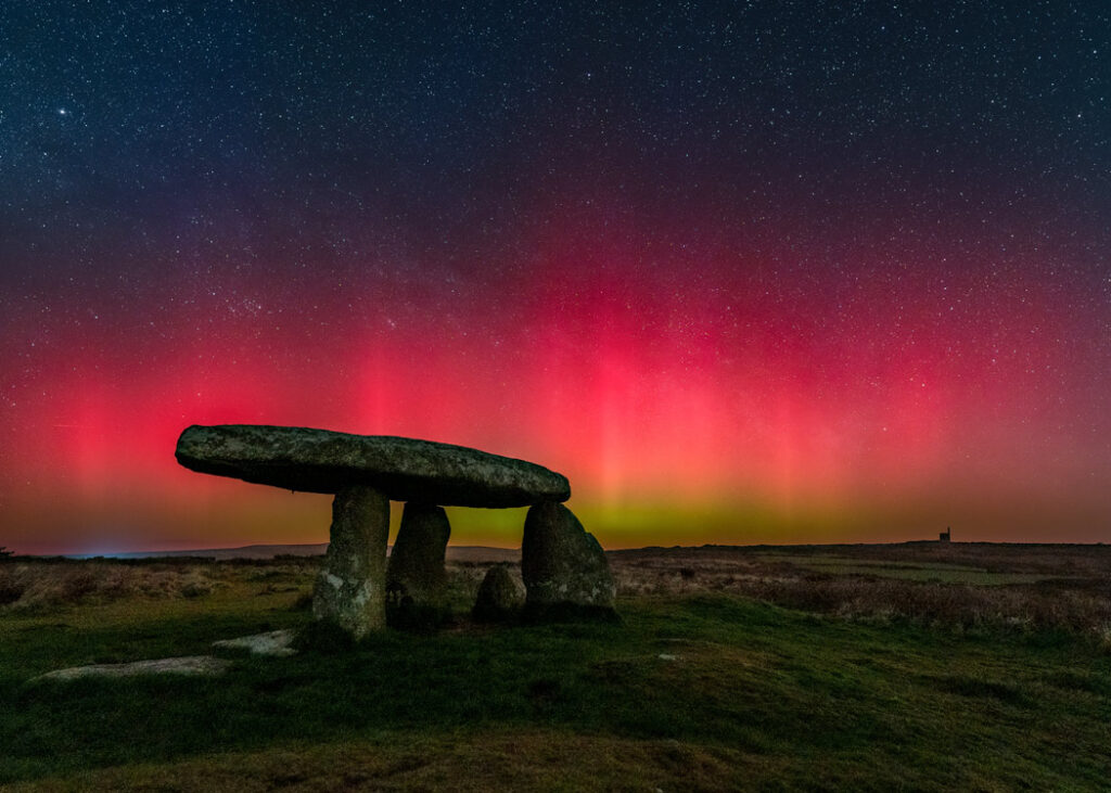 Aurora borealis glowing above Lanyon Quoit, Cornwall – May 2024