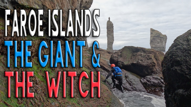 Coasteerer scrambles toward towering sea stacks, The Giant and The Witch, in the Faroe Islands