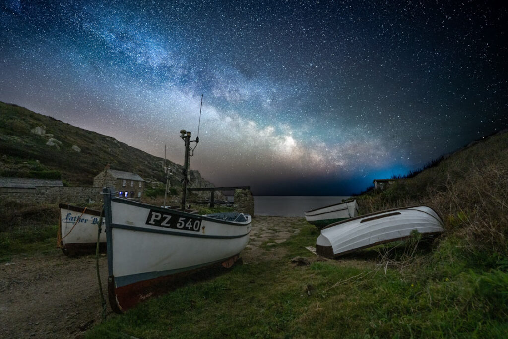 Milky Way rising over traditional fishing boats at Penberth Cove, Cornwall