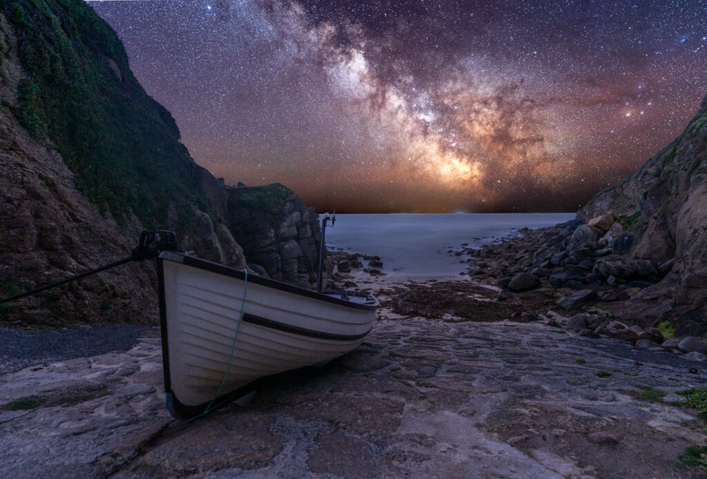 Milky Way arching over slipway and fishing boats at Porthgwarra, Cornwall