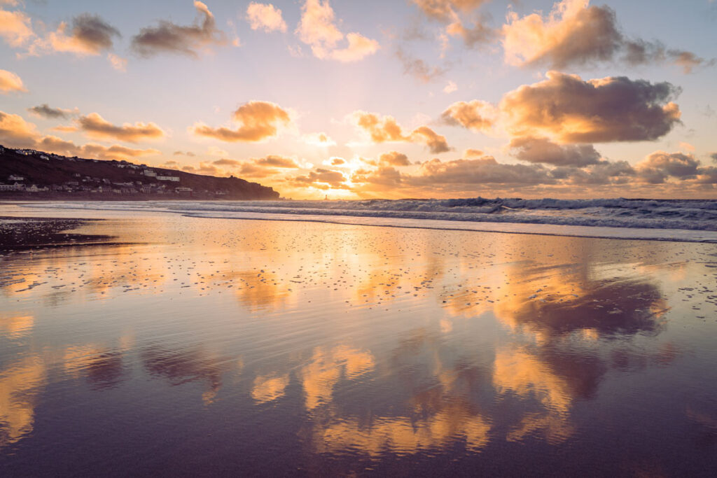 Golden sunset reflecting across wet sand at Sennen Beach, Cornwall – captured by Matt for a time-lapse project