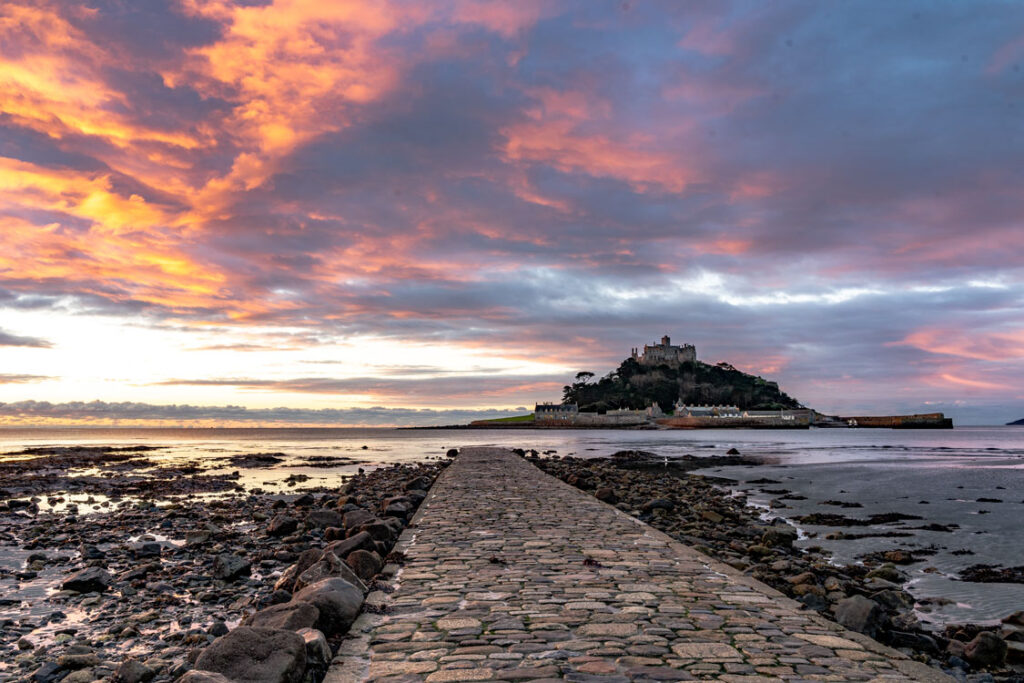 St Michael’s Mount at dawn with stone causeway and colourful sky